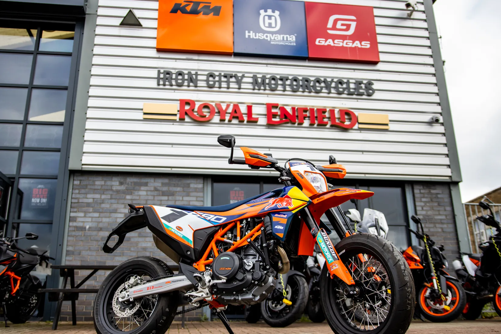 Iron City Motorcycles storefront in Leeds — a KTM 690 SMC R parked out front beneath the KTM, Husqvarna and GasGas dealer signage
